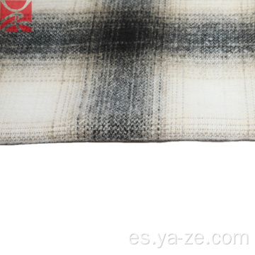 Revise la tela tejida de lana a cuadros de tweed para abrigos